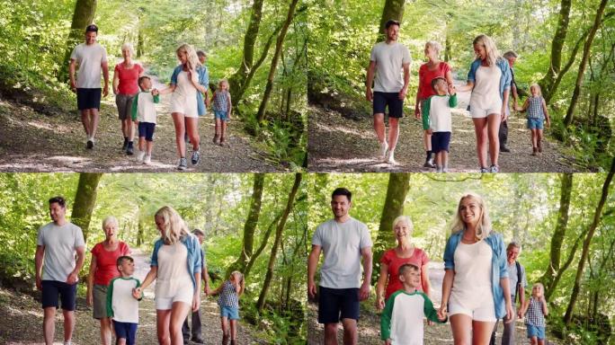 多代家庭一起沿着林地路径走向相机的慢动作拍摄