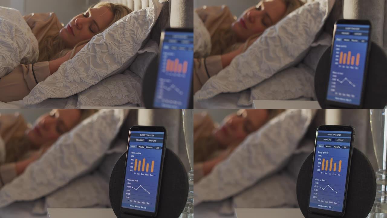 床上睡觉的女人床边用手机运行睡眠数据App