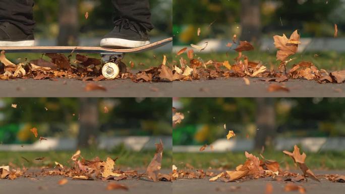 慢动作棕色和橙色的叶子在空中飞翔，因为未知的溜冰者沿着道路行驶