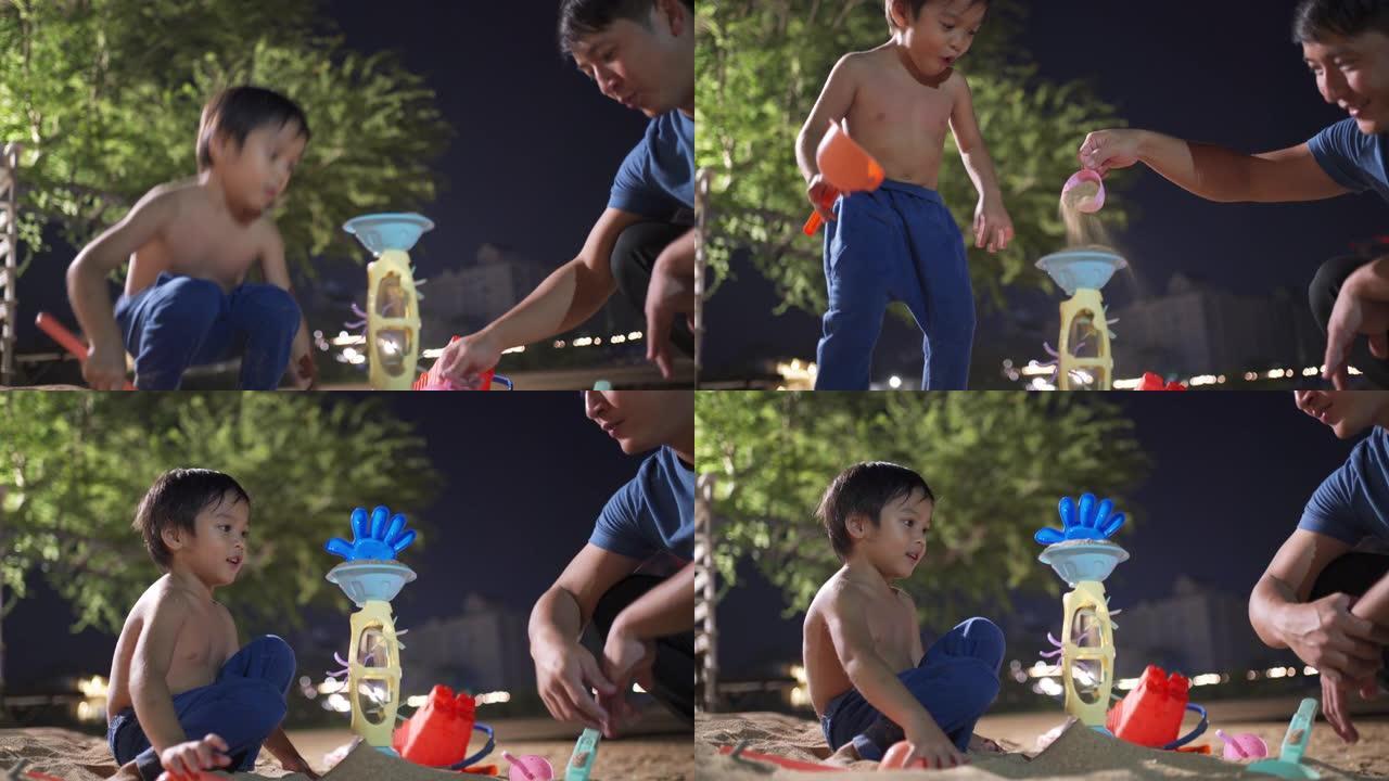 小男孩在沙滩上玩沙塔玩具