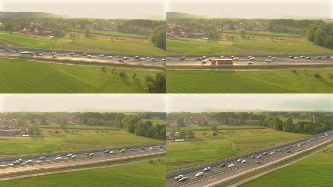 空中: 金色的夏日阳光照在高速公路上堵塞的车辆上