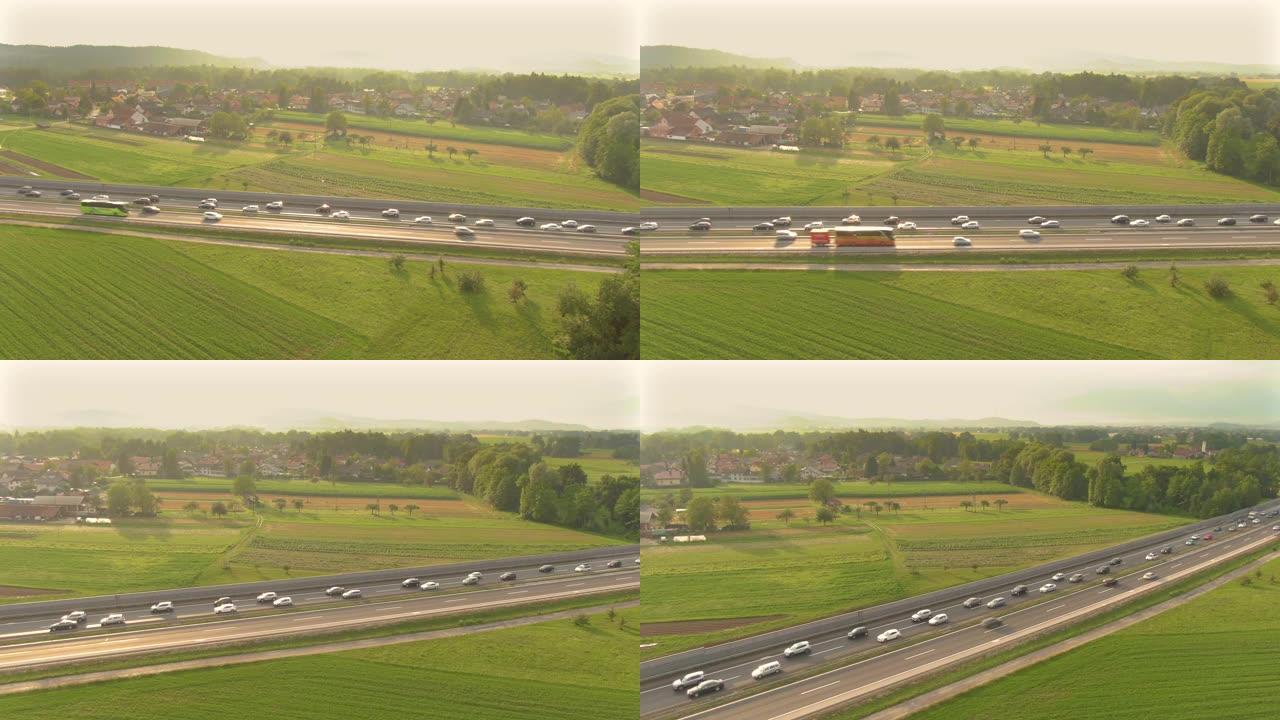 空中: 金色的夏日阳光照在高速公路上堵塞的车辆上