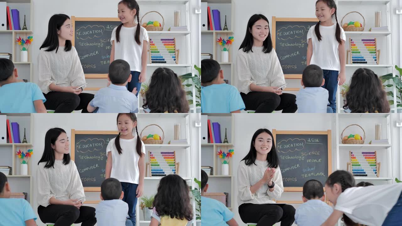 领导的微笑亚洲小女孩站在小学班级的演讲中。友谊，领导，教育，孩子，成功，志愿者，领导，教育，返校概念