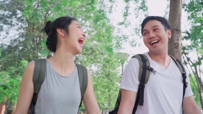 旅行者亚洲夫妇在泰国曼谷旅行和散步，甜蜜的夫妇在假日旅行中度过甜蜜的时光感到快乐。生活方式夫妇在城市