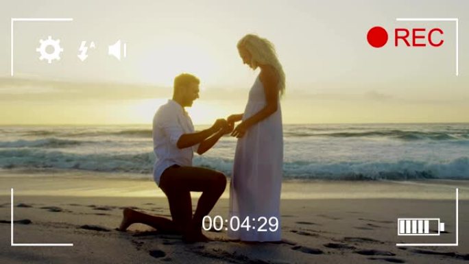 用数码相机4k在海滩上拍摄一对夫妇