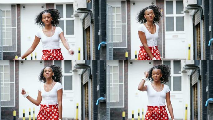 穿着红色圆点长裤的时尚年轻黑人妇女在街上跳舞