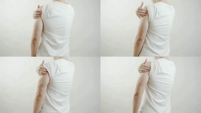 穿着白衬衫的亚洲男人感到肩膀疼痛。肌肉疼痛，保健概念。