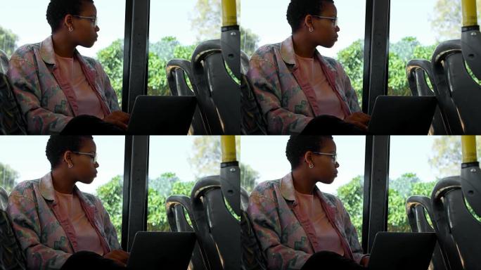 通勤者在4k公交车上使用笔记本电脑时透过窗户看