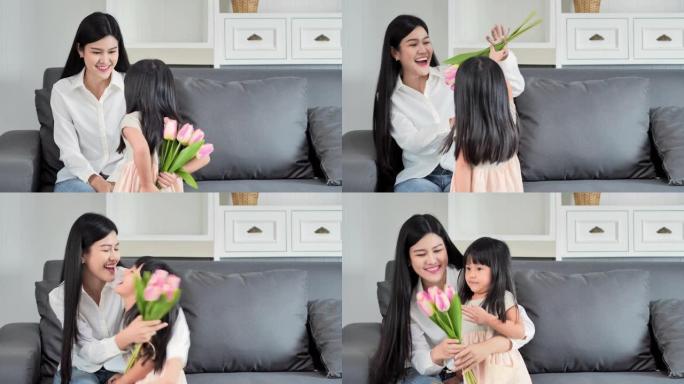 童女祝贺母亲，并给郁金香一束鲜花。女儿在母亲节用鲜花给母亲惊喜。母亲节概念。