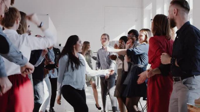 快乐有趣的年轻西班牙裔经理女商人在办公室与多民族团队一起做史诗舞蹈慢动作红色史诗。