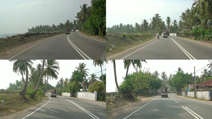 MS汽车沿着斯里兰卡热带道路的阳光行驶