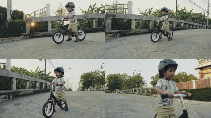 亚洲男婴 (2岁) 在泰国家附近骑自行车