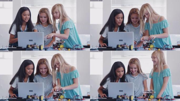 三名女学生在课后计算机编码课上建造和编程机器人车辆