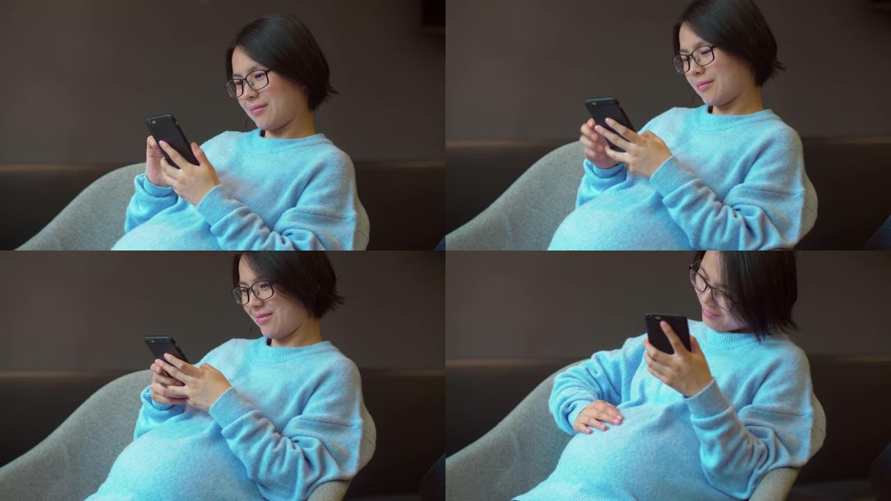 中国孕妇坐着使用手机