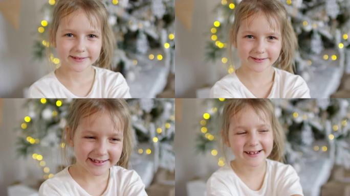 快乐的小女孩在圣诞树附近为相机摆姿势