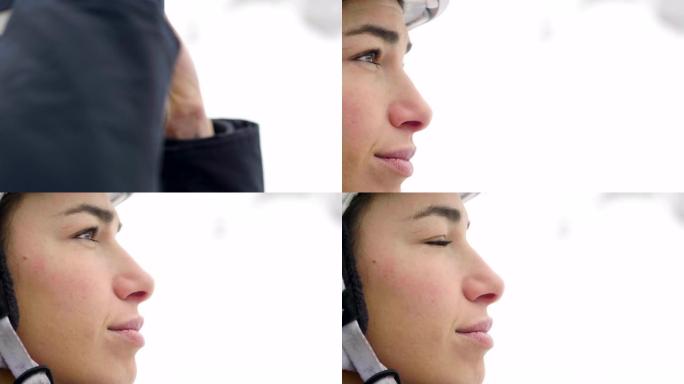 一个微笑的滑雪者在山上度假的肖像，在她身后你可以看到白雪覆盖的山。