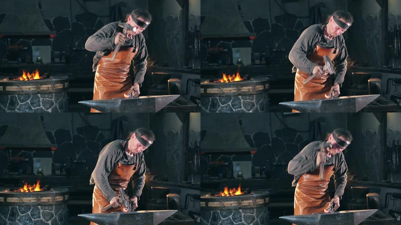 铁匠正在用锤子打铁。慢动作。