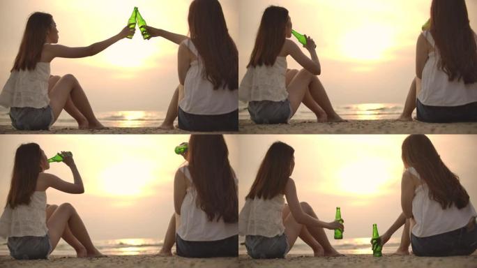 两个女人的朋友在日落时碰碰啤酒瓶