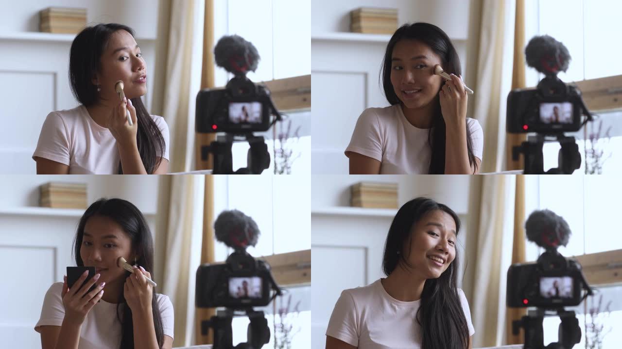 快乐年轻迷人的越南女人博客录制视频。