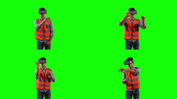 使用带有绿屏的虚拟现实的现场工作人员的前视图