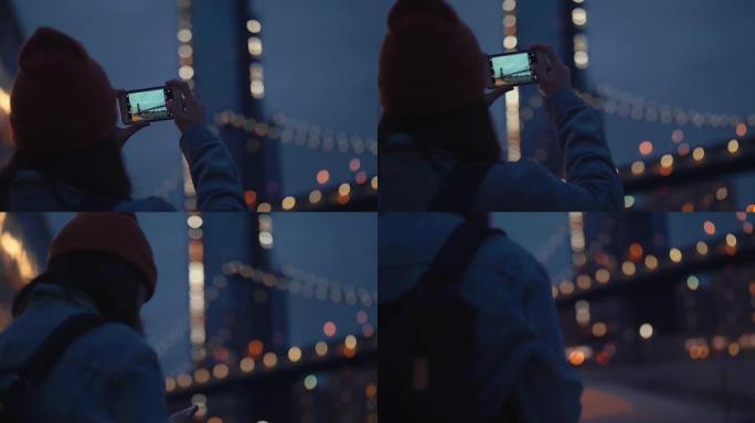亚洲女性游客使用智能手机在晚上拍摄河流的照片全景。