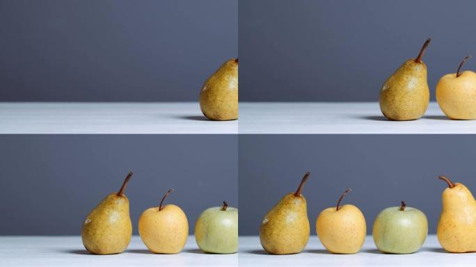 白色桌子上的苹果和梨