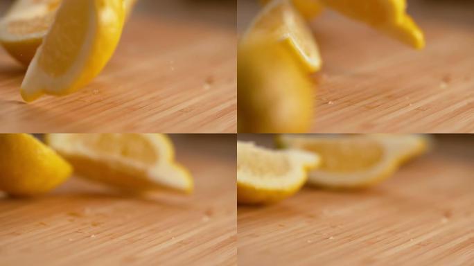宏观: 芳香明亮的黄色柠檬四分之一落在木制砧板上。