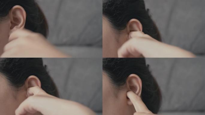 4k分辨率亚洲妇女将手指插入她发痒的耳朵。医疗保健和医疗概念。