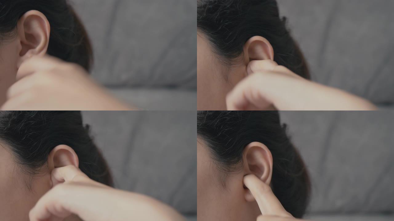 4k分辨率亚洲妇女将手指插入她发痒的耳朵。医疗保健和医疗概念。