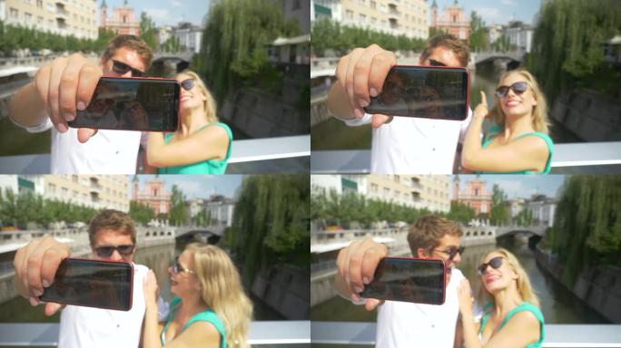 特写: 旅游夫妇在从桥上自拍时做鬼脸。