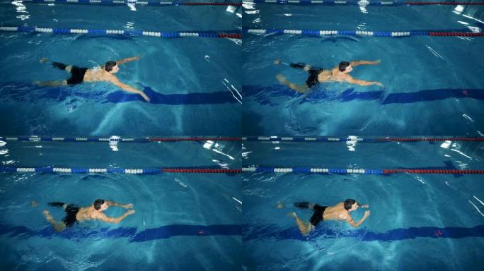 带有假肢的运动员在游泳池中游泳，俯视图。