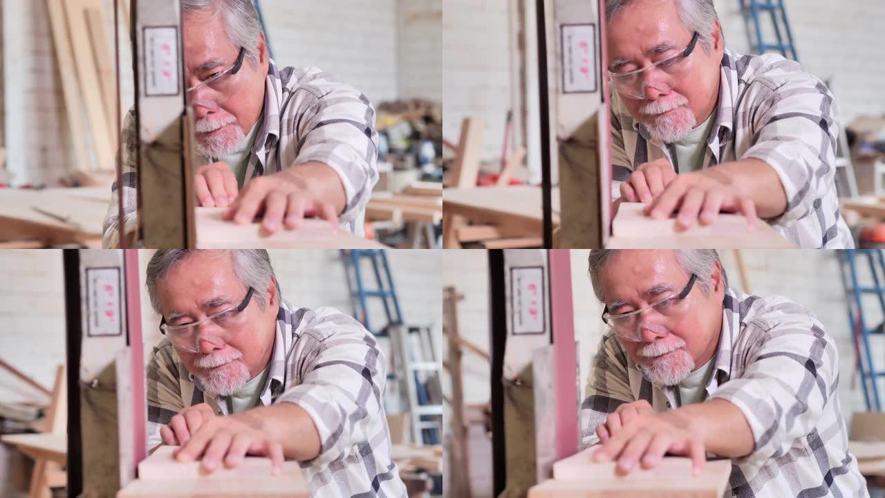 亚洲高级木匠的肖像做DIY工作，组装家具和使用研磨机，呆在家里防止冠状病毒或Covid-19.Loc