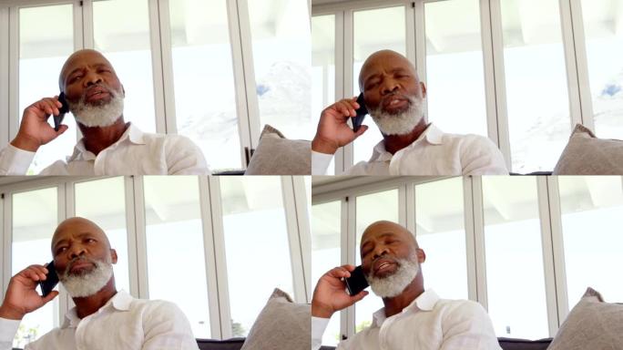 在舒适的家庭中，成熟的黑人男子在手机上聊天的前视图4k