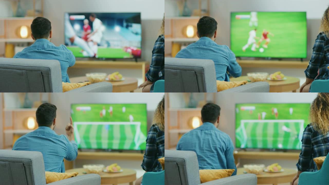 在家里，年轻夫妇在电视上观看足球比赛，他们担心，盖伊 (Guy) 积极地打手势，在他们的球队错过进球