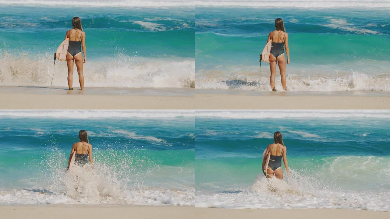 迷人的女人在海滩上冲浪