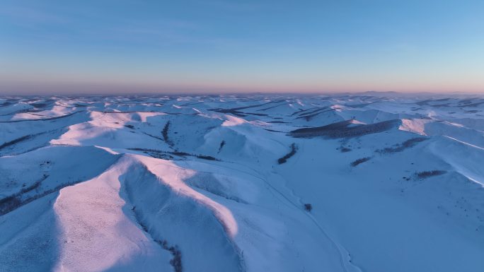 航拍冰雪覆盖的雪原雪岭晨光