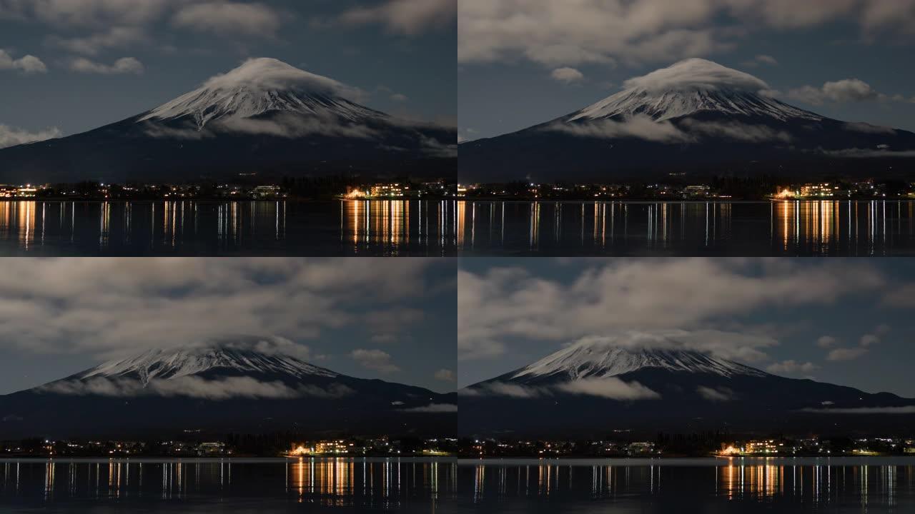 富士山上的云层在夜间在河口湖移动