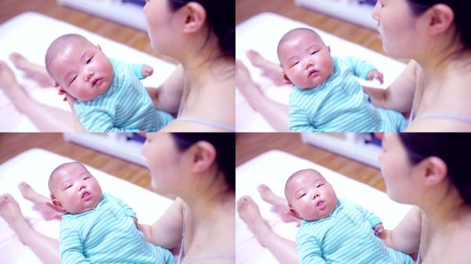 母亲双手抱着新生婴儿