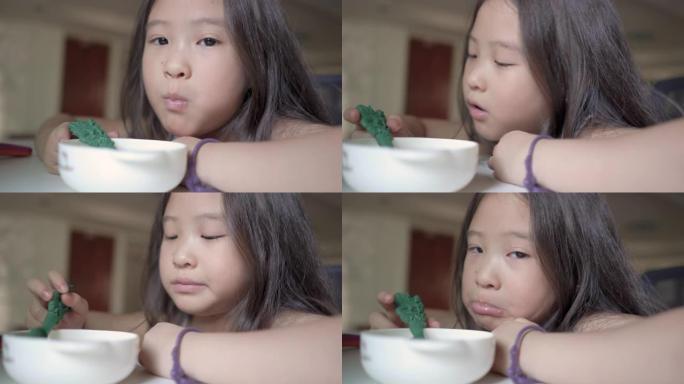 特写可爱的亚洲小女孩早上吃麦片