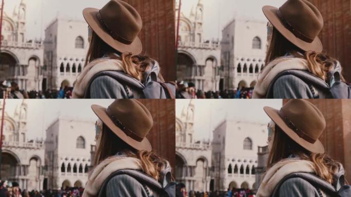 在威尼斯慢动作中，戴着时尚帽子和传统狂欢节面具的长发女人的特写镜头。