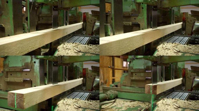 用工业锯木厂从原木上锯切木板的特写