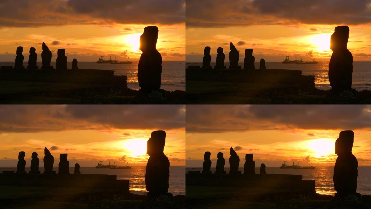 复制空间: 日落照亮后面的摩艾雕像和渔船