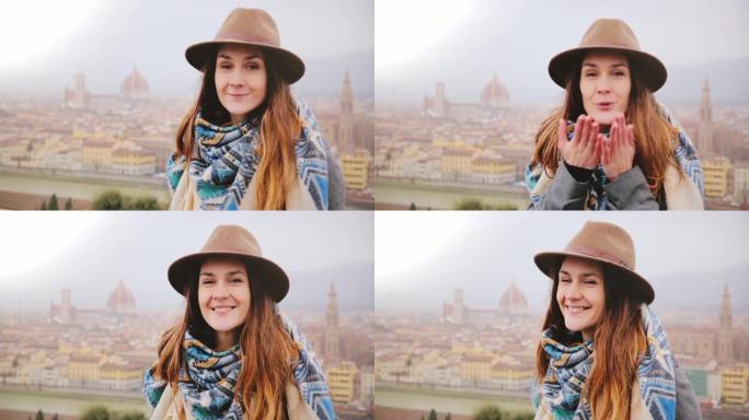 年轻美丽的高加索女人的肖像微笑着快乐，在雨天看着佛罗伦萨的相机飞吻。