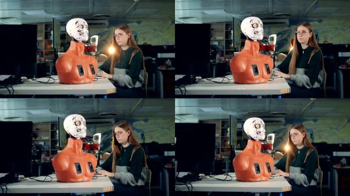 女孩正在用电脑操纵机器人的脸