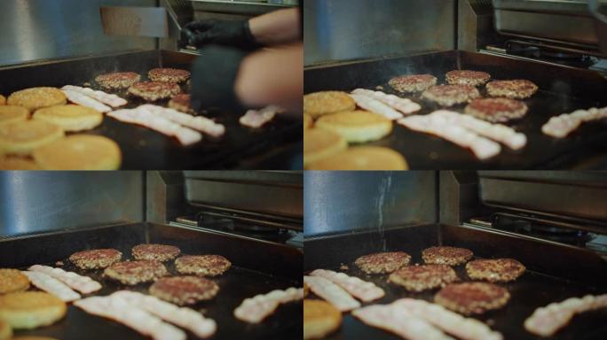 在烤架上准备的肉饼的美味特写镜头。新鲜的碎牛肉在热电烤架上烤。库克正在把肉末变成汉堡的肉饼，并用盐调