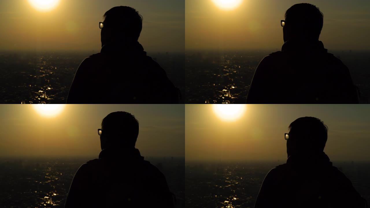 剪影亚洲男子在日本东京看日落城景