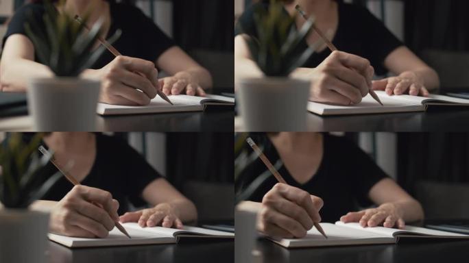 4k Dci解决方案女性职业自由职业者利用她的创造性技能在办公桌上工作，而作家正在她家的笔记本上写一