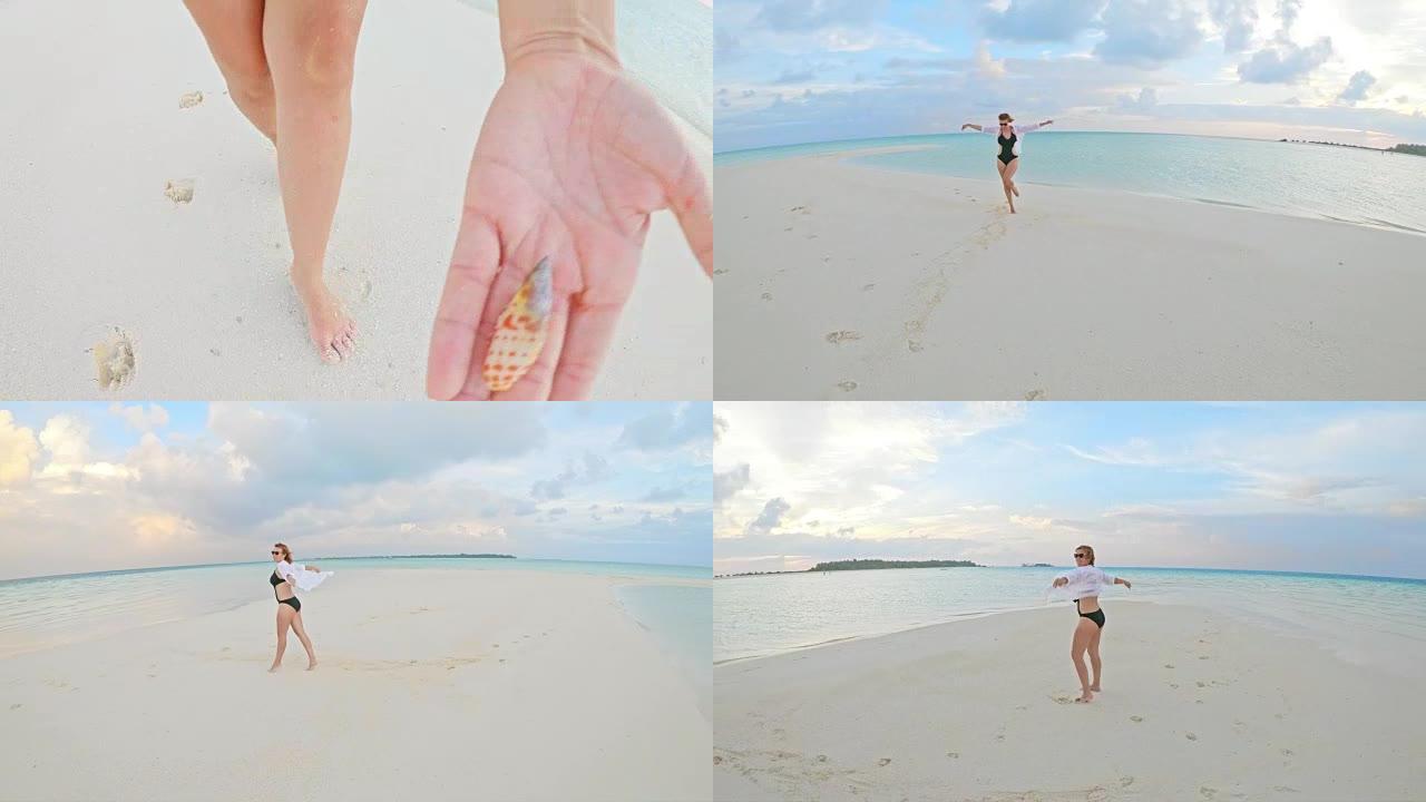 CU到马尔代夫热带海洋海滩上拿着贝壳的女士