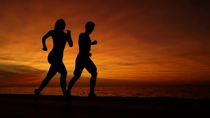 慢动作: 在一个壮观的橙色灯光晚会上进行未知的健康跑步者训练。