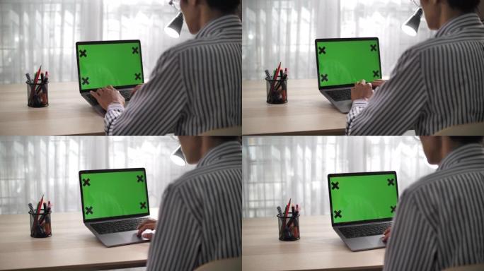 在家里的桌子上使用色度键屏幕笔记本电脑的特写镜头